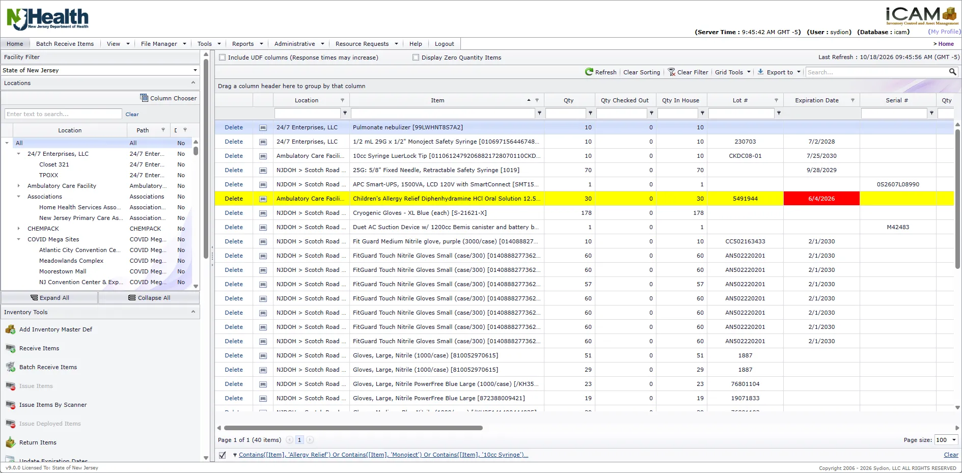The iCAM home screen. On the left, a facility filter, a tree of facilities and storage locations, and a list of inventory tools such as Receive Items and Batch Receive Items. On the right, the inventory grid lists items by location with quantity, quantity checked out, quantity in house, lot number, expiration date and serial number. One expired lot is highlighted in yellow with its expiration date in red.